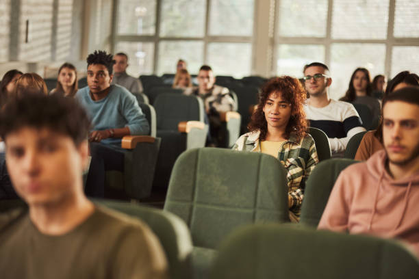istock College students attending a class in amphitheater. 1456220489
