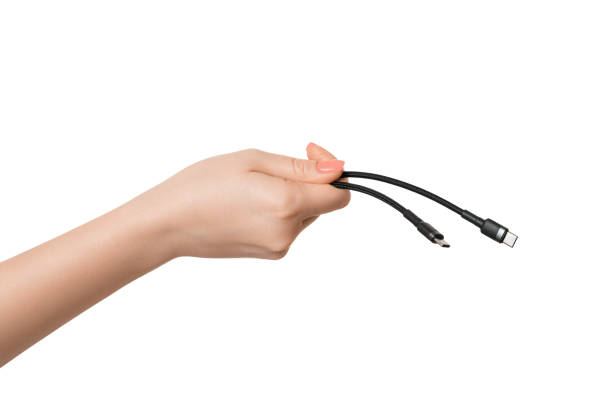 istock Type C charging wire in a male hand on a white background, isolate. 1456220560