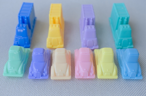 Concept image series of plastic toy cars and trucks in pastel colors illustrating situations. These photographs can be useful as dividers, illustrations, the introduction of an idea, a demonstration or a presentation.