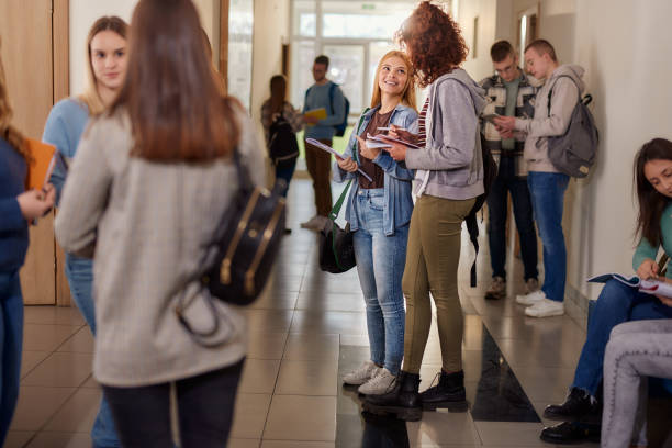 istock Large group of students learning in a hallway. 1456221313