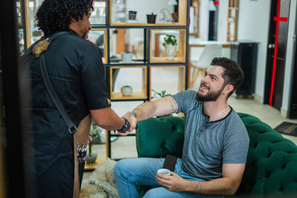 istock male stylist performs haircut to a client 1456224792