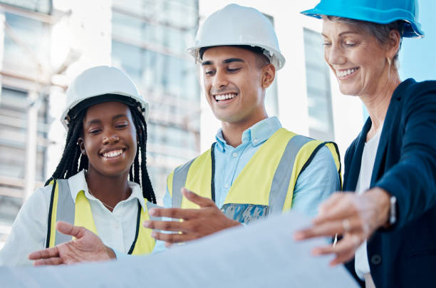 istock Architect team, blueprint and meeting for construction planning, discussion or collaboration on site. Happy industrial engineers in teamwork conversation for building, architecture or project plan 1456225094