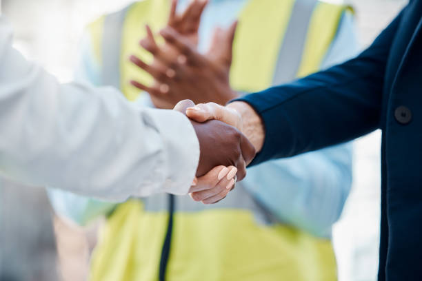 istock Handshake, success deal or partnership for construction worker, building engineer or architect finance, sales or investment funding. Zoom, men or architecture woman in agreement on real estate goals 1456225097