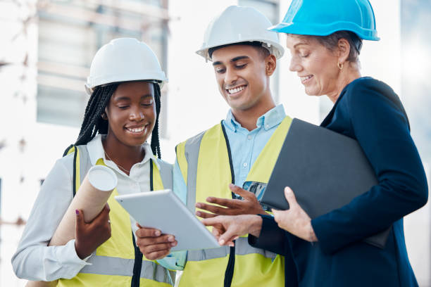 istock Architecture, construction and architects planning with a tablet for building, renovation and design on internet. Engineering, teamwork and workers with strategy on tech for industrial infrastructure 1456225098
