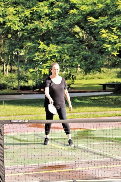 istock middle-aged woman playing pickleball 1456225494