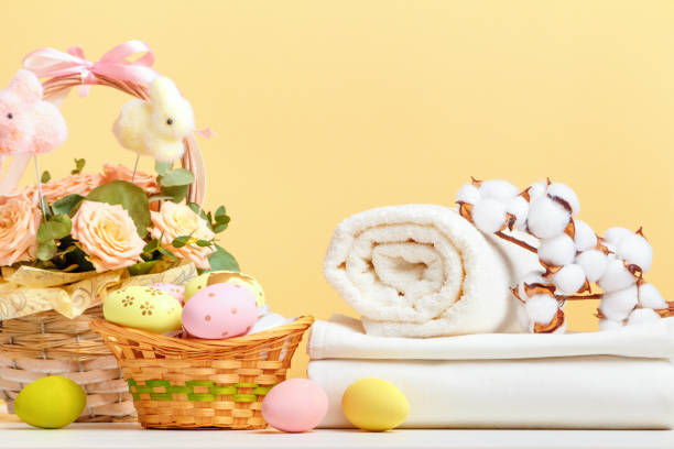 istock A stack of white bed linen and rolls of towels with Easter decor on the table. Still life copy space 1456226226