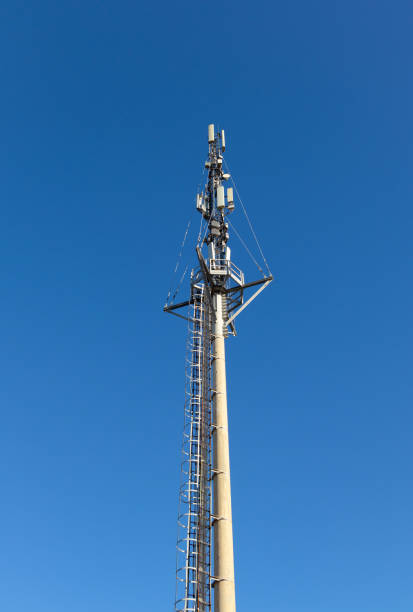 istock Communication tower with mobile cellular antennas against the blue sky 1456226795