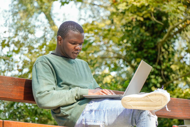istock boy from africa working with computer. digital nomad black people 1456227132