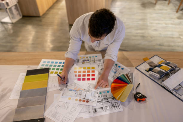 Interior designer drawing a design while working at a furniture store