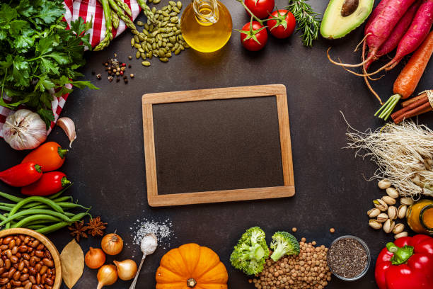 istock Healthy vegetables and spices frame on dark background. Copy space 1456229639