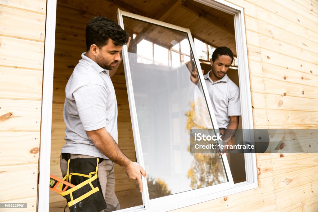 Worker Installing Window Insert Construction Workers Installing Windows Stock Photo - Download Image ...