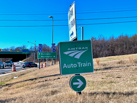 Lorton, Virginia, USA - January 9, 2023: A metal sign points passengers to the Lorton Amtrak Auto Train station near Interstate 95 the day the Southbound Auto Train began a 37-hour ordeal traveling to Florida.