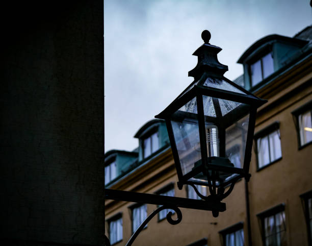 Low angle view of lamp post on building against sky