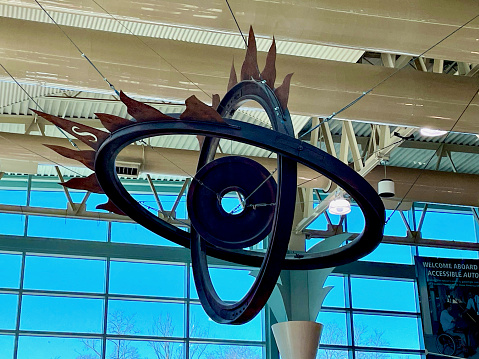 Lorton, Virginia, USA - January 9, 2023: A sculpture made from railroad track and train wheel parts hangs from the ceiling inside the Lorton Amtrak Auto Train station.