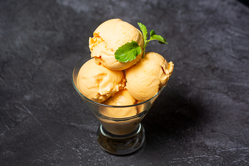 Mango Ice Cream served in cup isolated on grey background top view of indian and bangladesh food