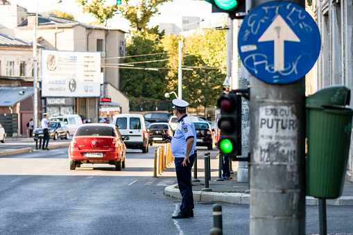 Police agent, Romanian Traffic Police (Politia Rutiera) directing traffic. Rush hour in Bucharest, Romania, 2022