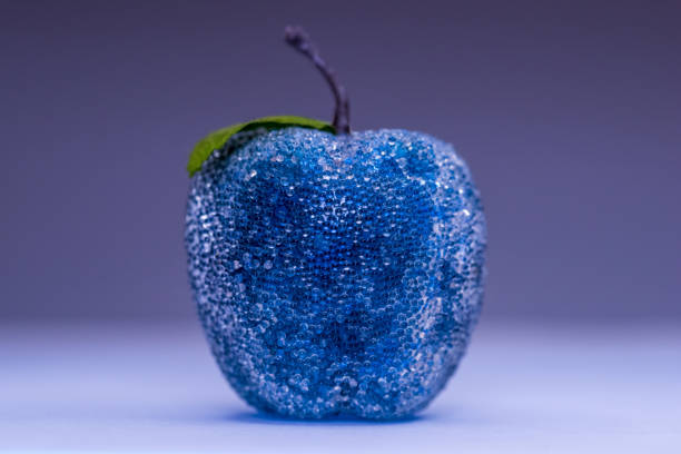 Wet apple in abstract lighting.