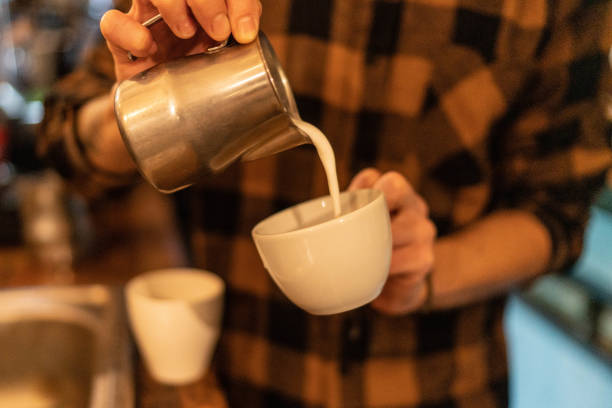 istock Barista making coffee latte art in a coffee shop 1456236608