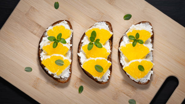istock Toasts with cottage cheese and orange on a cutting board 1456237017