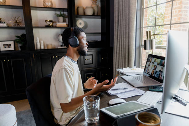 istock Young adult man talks to peers 1456237384