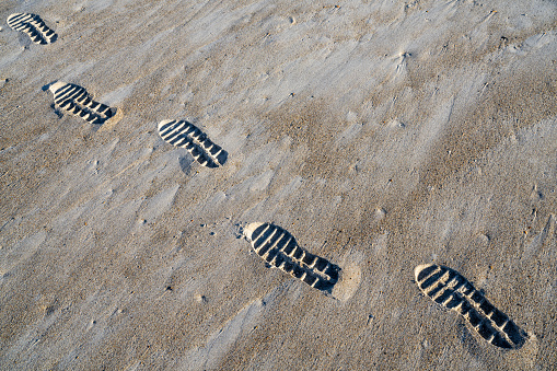 Footprint on a sandy beach, Semporna, Sabah, Malaysia.
