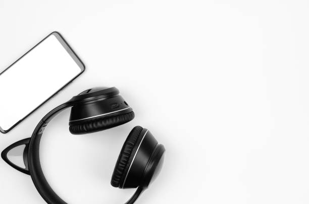 istock Wireless headphones and smartphone on white background, copy space 1456240892