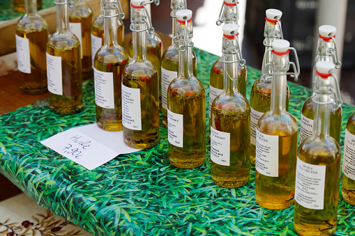 Nice, France - 18 September 2018: At the stall, oils for food purposes were put up for sale. The choice of flavors and flavorings is described on the labels on glass bottles.
