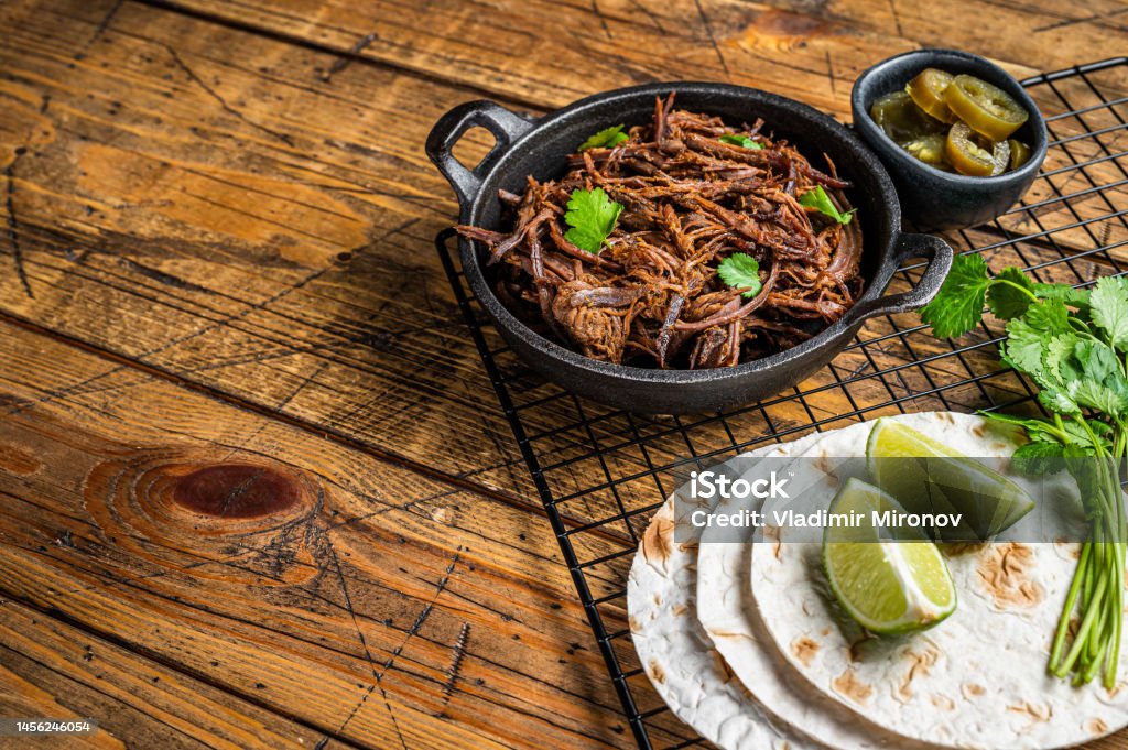 Cooking of mexican pork carnitas taco. Wooden background. Top view. Copy space Cooking of mexican pork carnitas taco. Wooden background. Top view. Copy space. Avocado Stock Photo