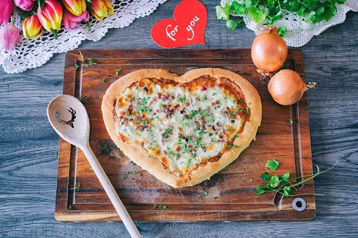 Homemade Italian pizza heart for you from fresh ingredients.