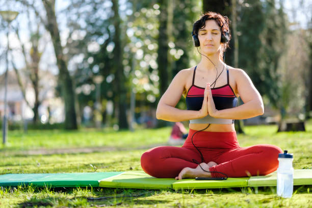 istock woman doing yoga in the park 1456253298