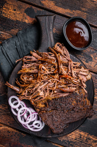 istock Traditional barbecue wagyu pulled beef on wooden board. Wooden background. Top view 1456253330