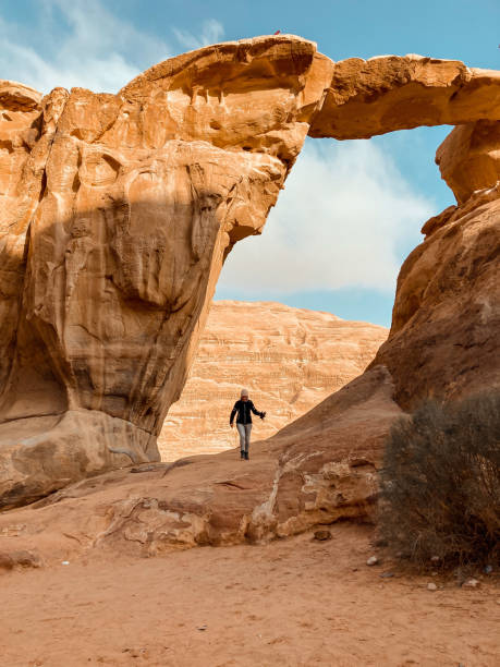 istock walking under an arch, wadi rum, jordan 1456255117