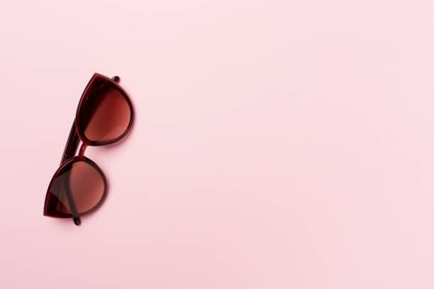 istock Sunglasses on color background, top view 1456255279