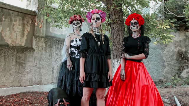 Slow motion Costumed performance of Women in the guise of Holy Death with dogs. Traditional Dia de Los Muertos Festival in Mexico