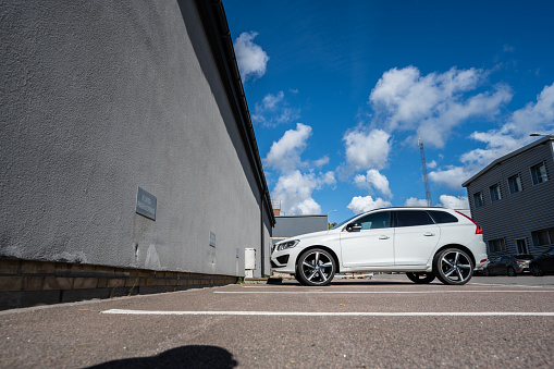 Gothenburg, Sweden - september 21 2022: White Volvo parked by the wall of a warehouse.