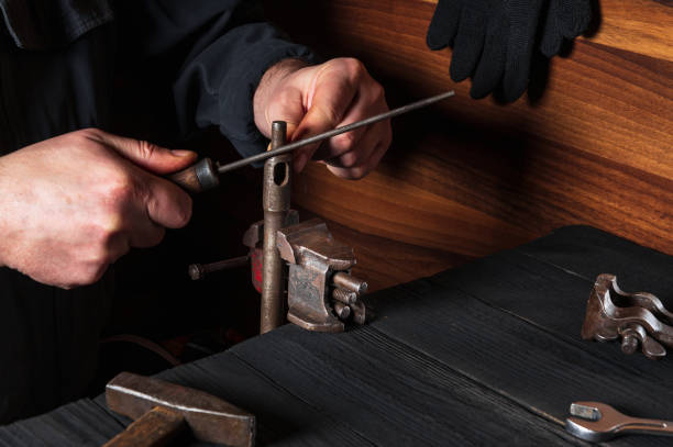 istock The master grinds the part with a file in a vice. Working environment in the workshop 1456257349