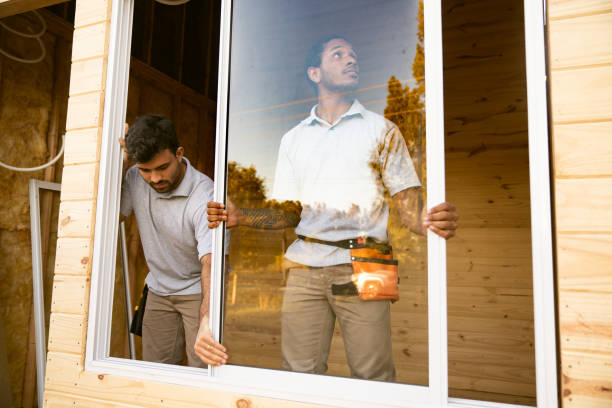 Construction workers installing windows stock photo