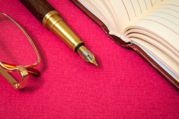 istock Office still life red table with a notebook, gilt pen and glasses businessman prepare for notes 1456258383