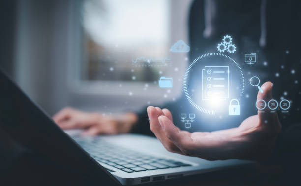 istock Businessman working on laptop with virtual screen. Online documentation database, IT consultant being set up Virtual Document Management System with laptop,Software for archiving corporate files. 1456259524