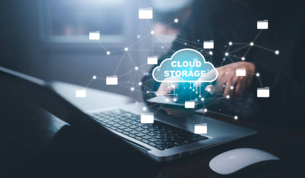 istock Businessman hand holding smartphone and laptop with cloud computing diagram show on hand. Cloud technology. Data storage. Networking and internet service concept, Cloud sharing download and upload 1456260158