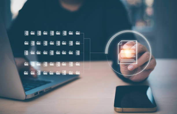 istock Businessman working on laptop and touch screen Online documentation database, IT consultant being set up Virtual Document Management System with laptop,Software for archiving corporate files. 1456260670