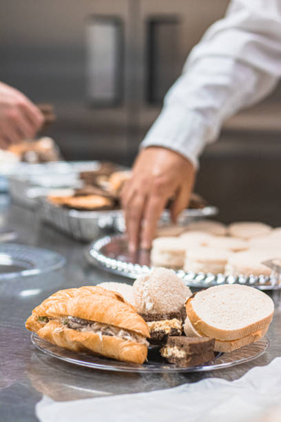 istock Servers in the kitchen preparing finger foods for a tea party 1456265076