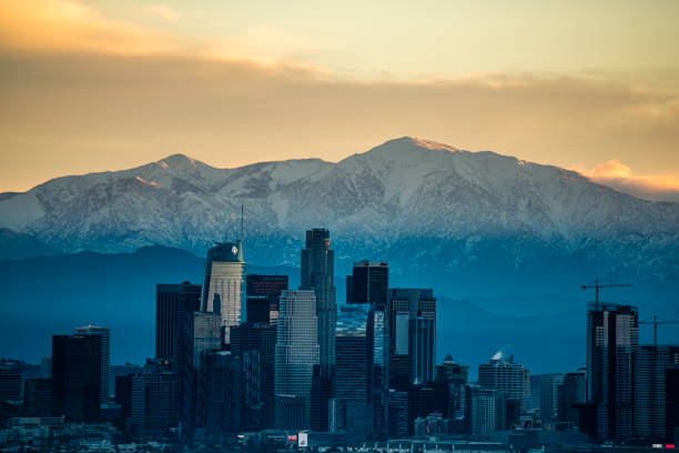 istock Los Angeles Skyline Contrasts Snow Capped Mountains 1456265335