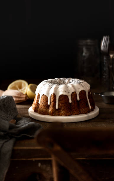 istock Table Scape with Lemon Drip Cake and Poppy Seeds 1456266073