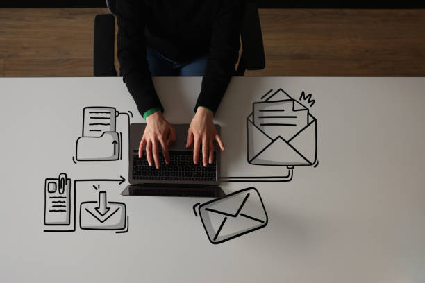 istock Woman using laptop with envelope icons 1456272192