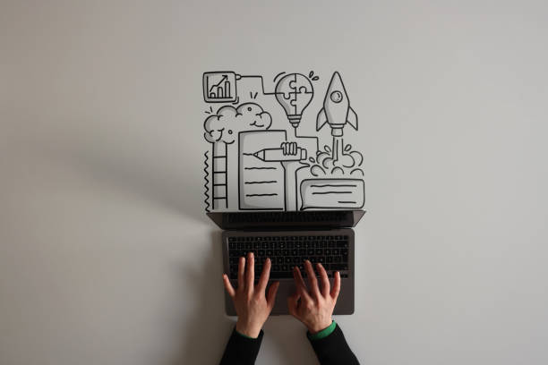 istock Woman using laptop with business plan icons 1456272226