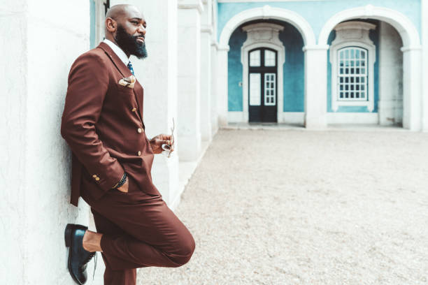istock An elegant male leaning on a wall 1456272256