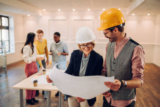 istock Portrait of two architect looking at blueprints in an office 1456274825