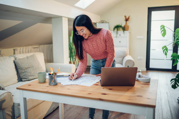 istock Vietnamese Asian woman using laptop while working at home 1456274848
