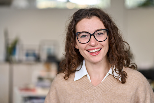 Young happy professional business woman, smiling laughing female office worker, hr manager wearing glasses looking at camera advertising job opportunities, optics, business services. Headshot portrait